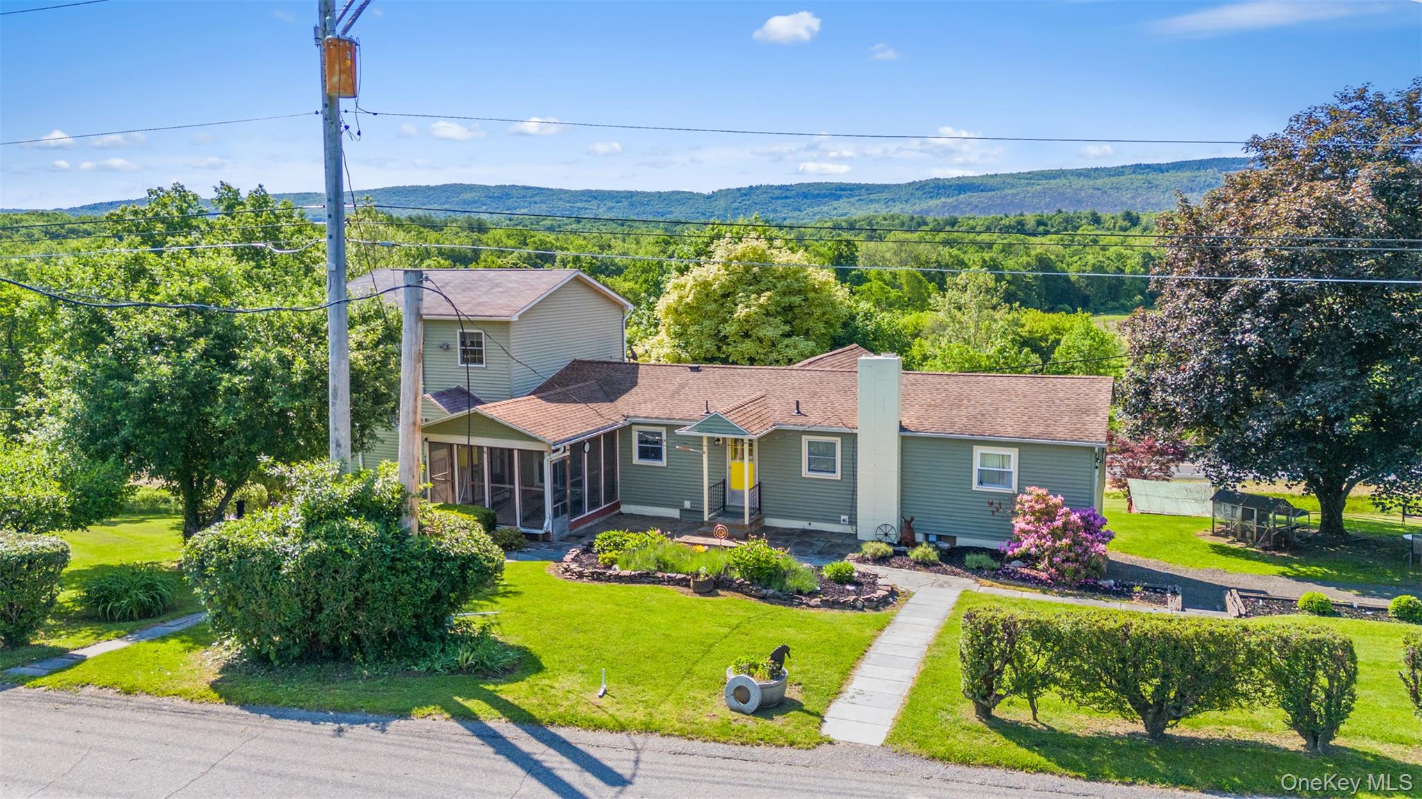 a front view of a house with a yard table and chairs