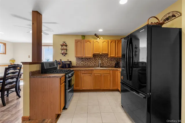 a kitchen with stainless steel appliances granite countertop a refrigerator a sink a stove and island