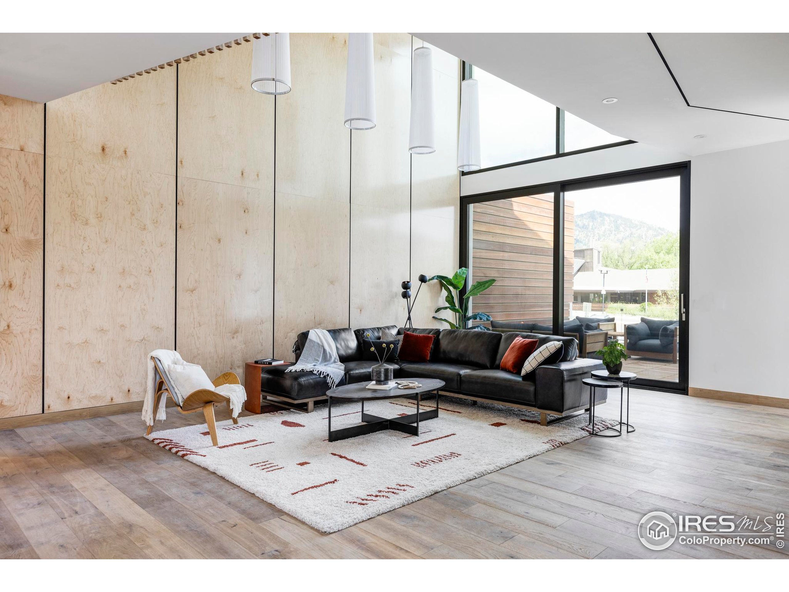 944 Arapahoe Avenue, Unit A Boulder, CO 80302 - Photo 13 of 36 a living room with furniture large window and wooden floor
