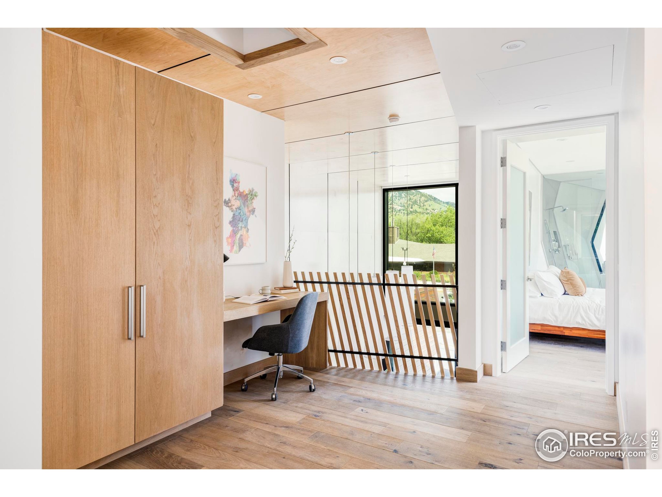 944 Arapahoe Avenue, Unit A Boulder, CO 80302 - Photo 23 of 36 a view of a bedroom with wooden floor and a window