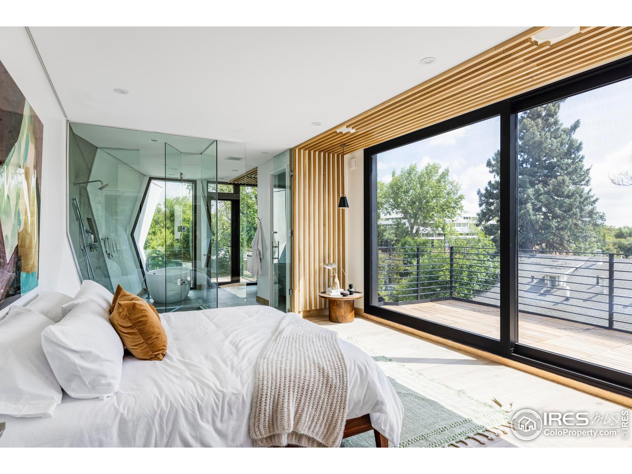 944 Arapahoe Avenue, Unit A Boulder, CO 80302 - Photo 25 of 36 a bedroom with a large bed and a large window