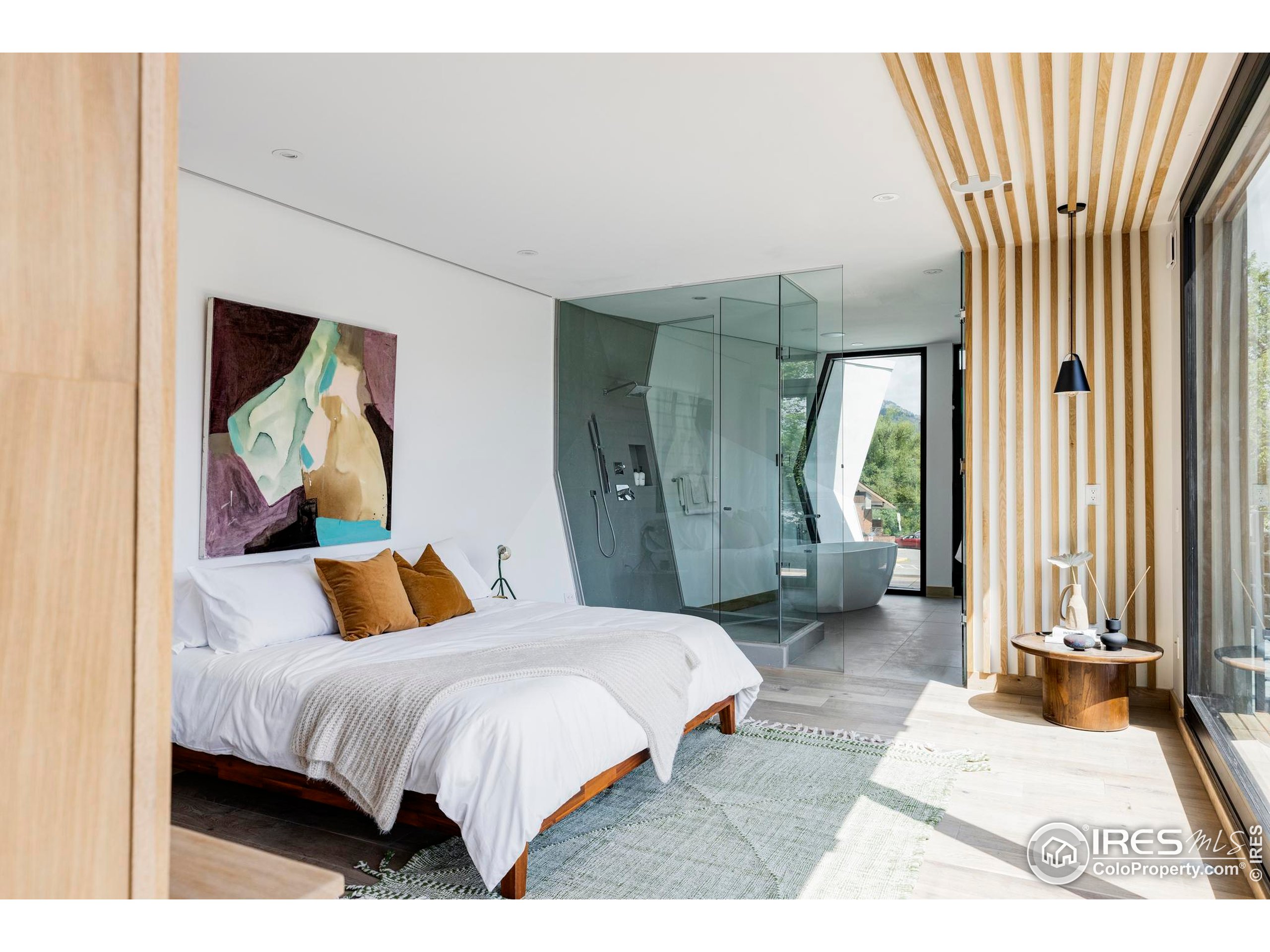 944 Arapahoe Avenue, Unit A Boulder, CO 80302 - Photo 26 of 36 a bedroom with a bed a mirror and a window