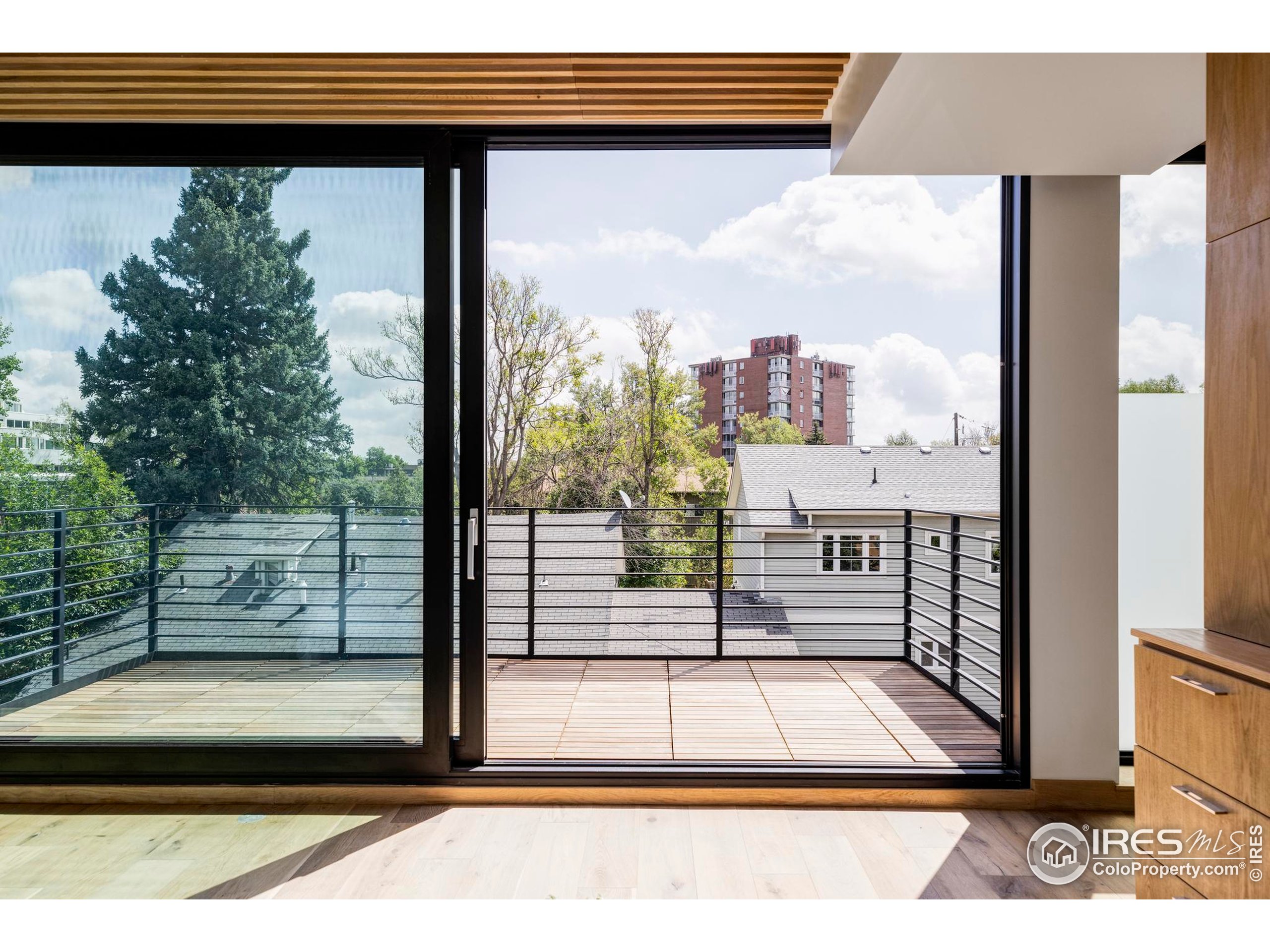 944 Arapahoe Avenue, Unit A Boulder, CO 80302 - Photo 27 of 36 a view of a balcony with floor to ceiling windows with wooden floor