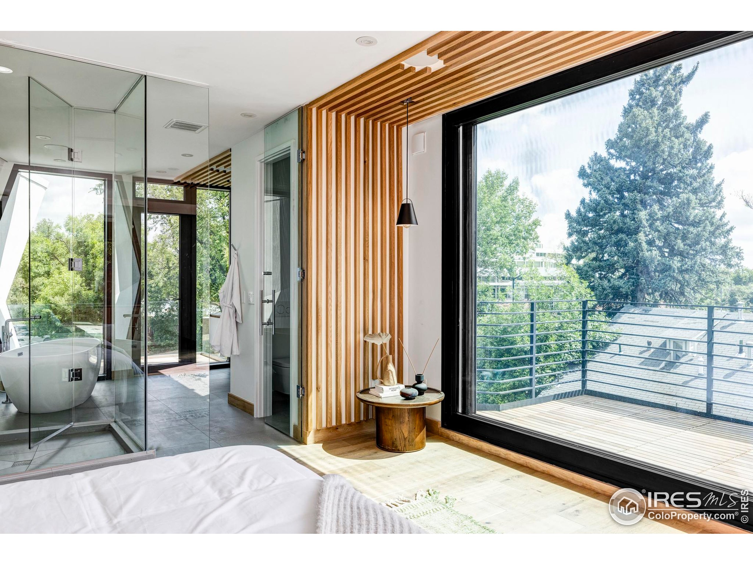 944 Arapahoe Avenue, Unit A Boulder, CO 80302 - Photo 29 of 36 a bedroom with a bed and wooden floor