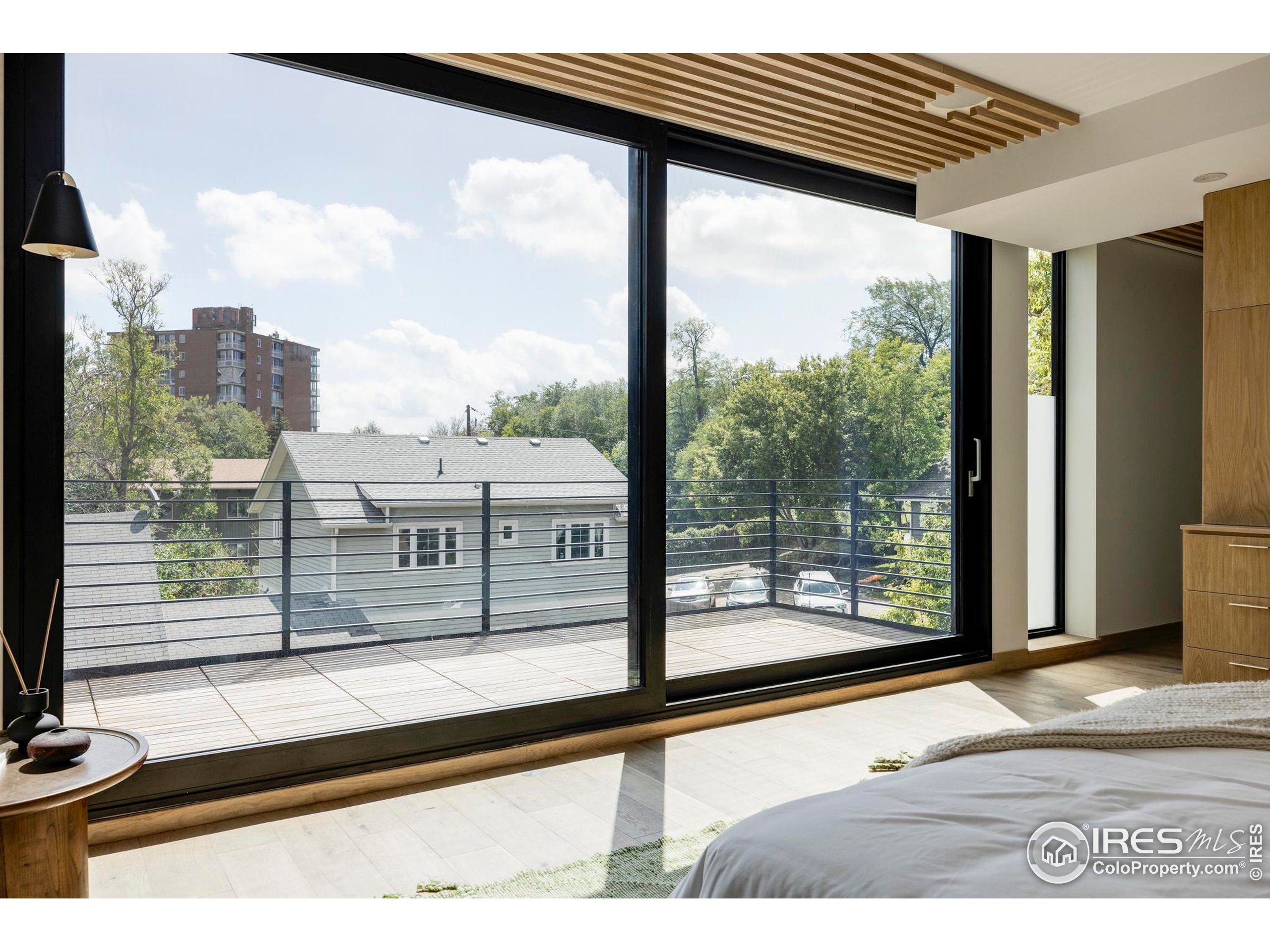 944 Arapahoe Avenue, Unit A Boulder, CO 80302 - Photo 35 of 36 a view of a balcony with floor to ceiling windows with wooden floor