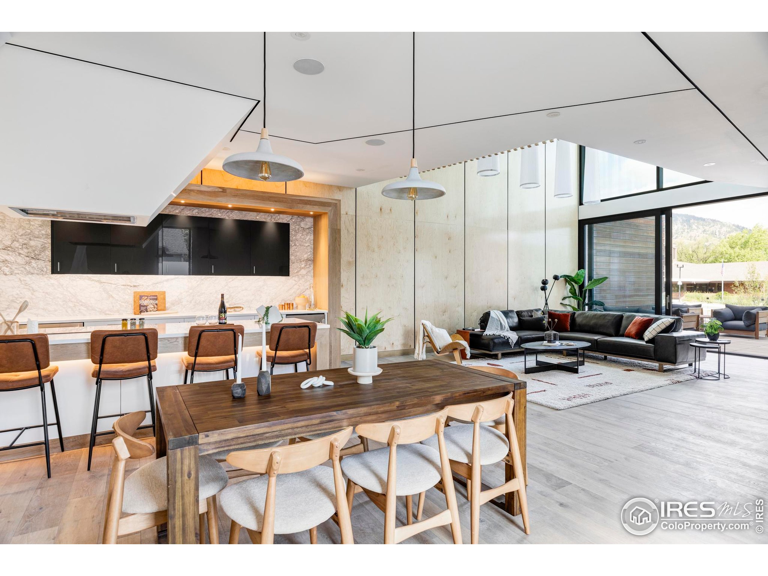 944 Arapahoe Avenue, Unit A Boulder, CO 80302 - Photo 5 of 36 a living room with couches a flat screen tv and kitchen view