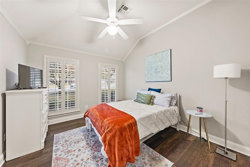 517 Chado Lane Robinson, TX 76706 - Photo 24 of 40 Bedroom #3 with vaulted ceiling, dark wood finished floors, crown molding, and a ceiling fan