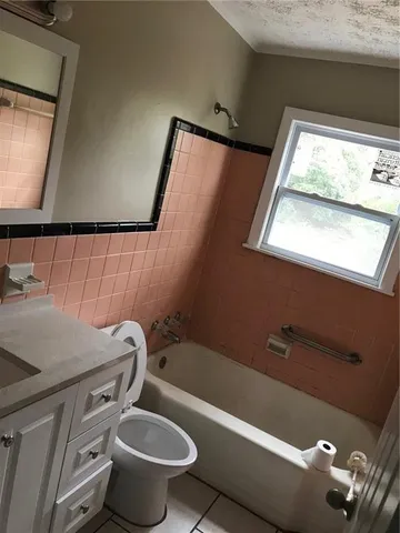 a bathroom with a toilet a sink and a mirror