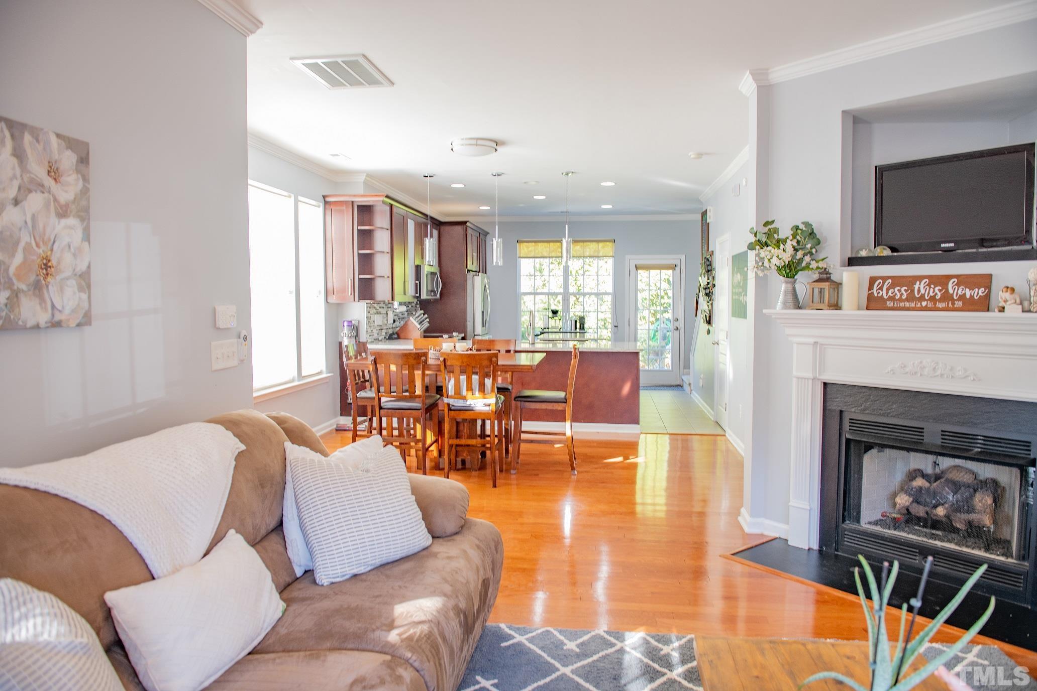 7826 Silverthread Lane Raleigh, NC 27617 - Photo 3 of 14 a living room with furniture and a fireplace