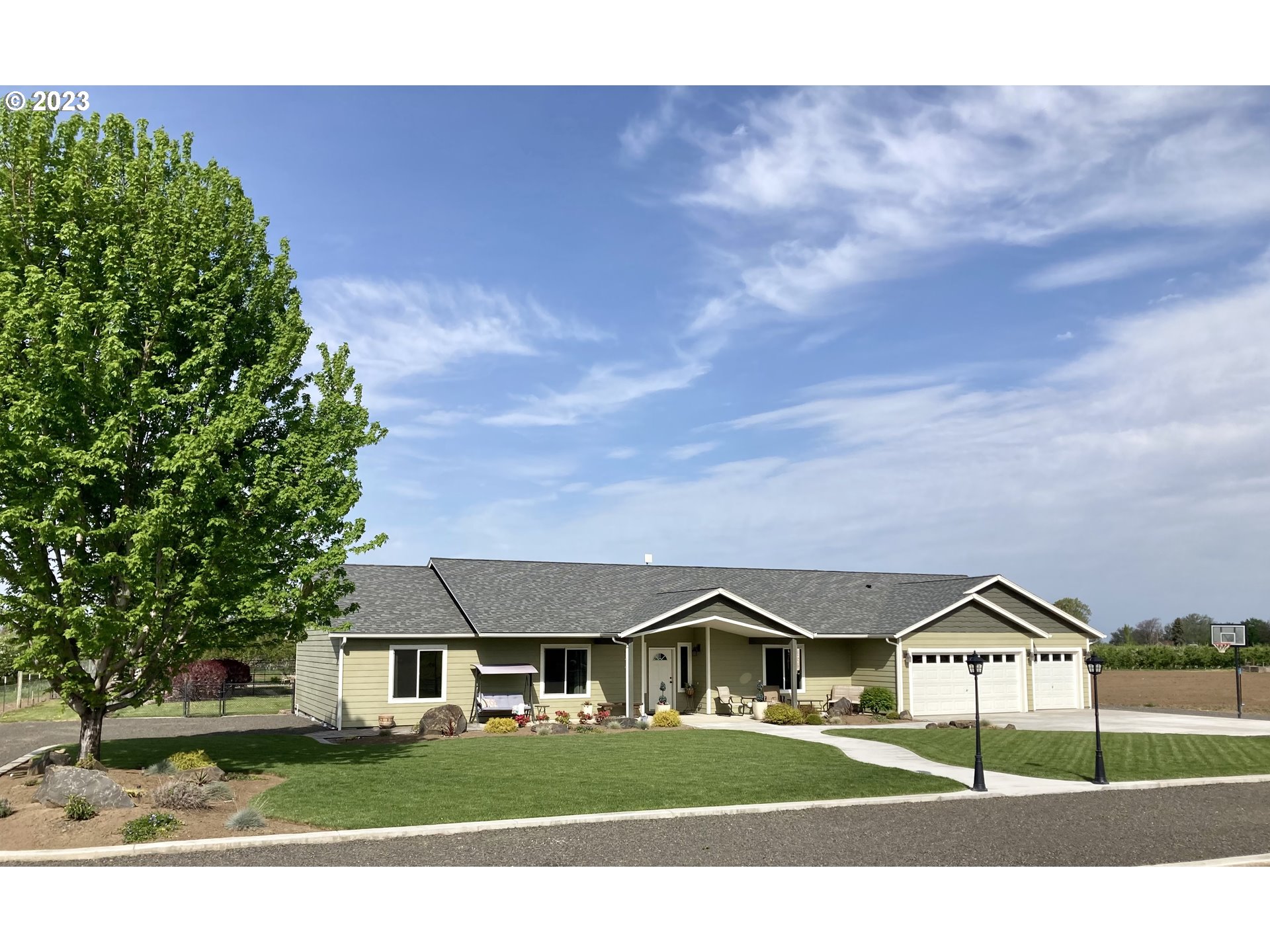a front view of a house with a garden
