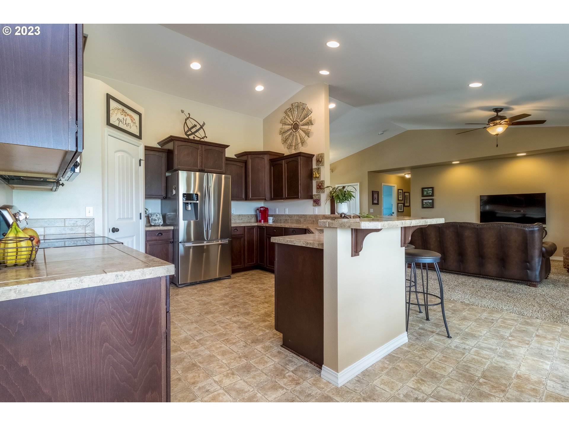 52794 Appleton Road Milton Freewater, OR 97862 - Photo 9 of 35 a kitchen with stainless steel appliances kitchen island granite countertop a sink refrigerator and cabinets