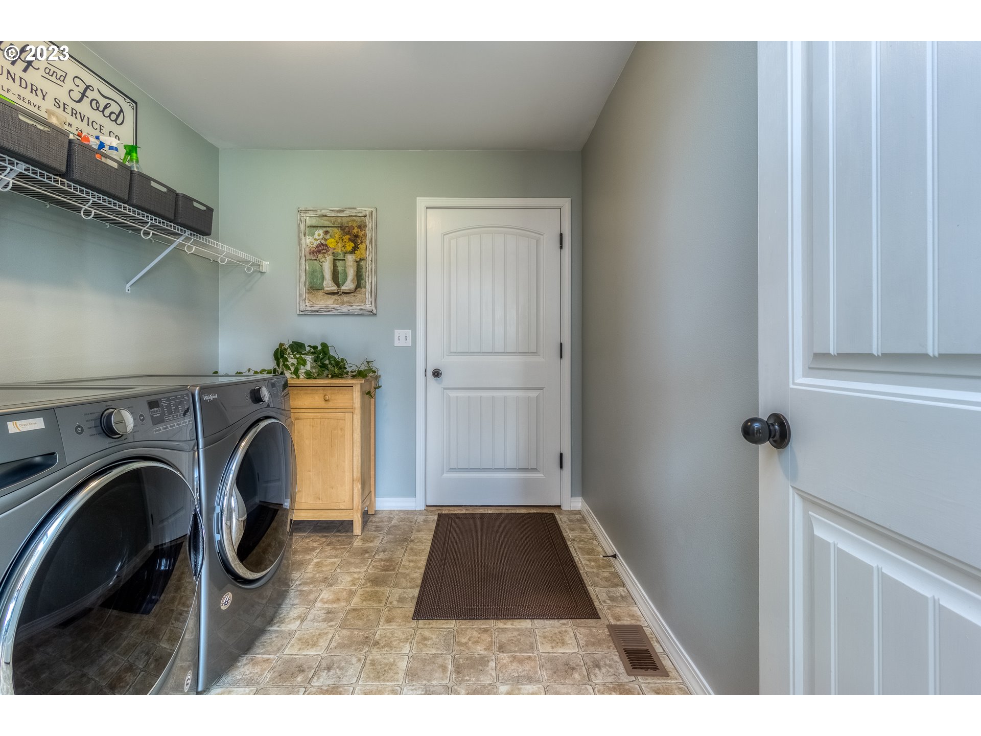 52794 Appleton Road Milton Freewater, OR 97862 - Photo 10 of 35 a view of washer and dryer with kitchen in the background