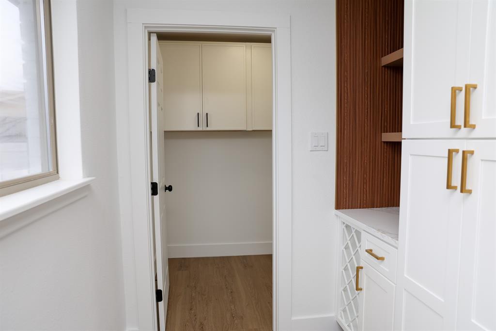 6508 Ember Court Plano, TX 75023 - Photo 7 of 38 Laundry room, pantry cabinet, wine rack with shelf