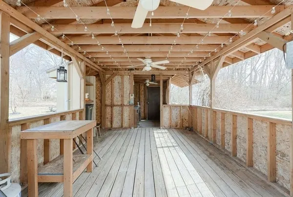 a view of a porch with wooden floor