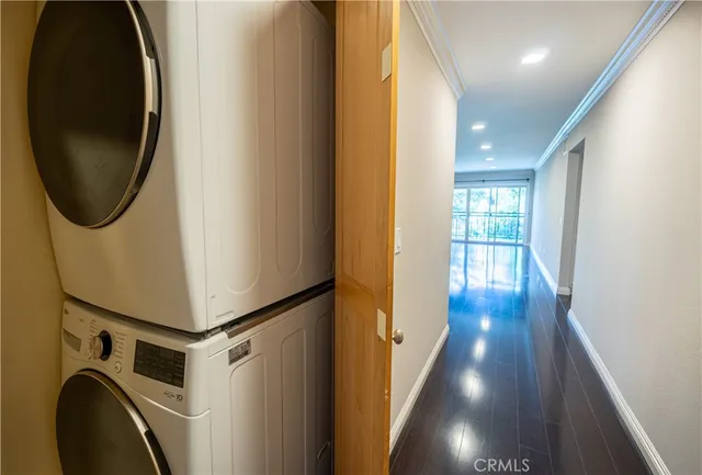 a view of a hallway with wooden floor and entryway