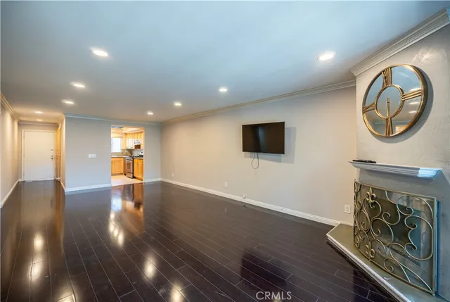 a view of a livingroom with furniture wooden floor and window