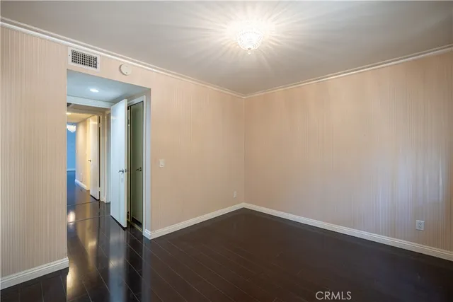 a view of a room with wooden floor and a window