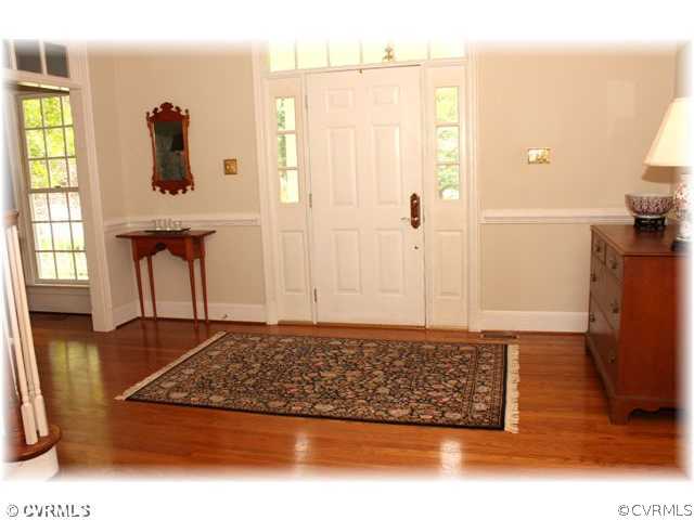 14420 Newgate Road Midlothian, VA 23113 - Photo 2 of 12 a view of a hallway with wooden floor and windows