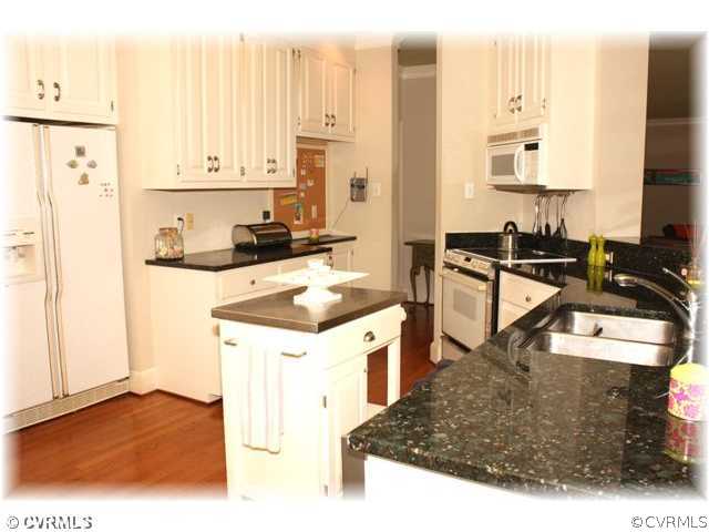 14420 Newgate Road Midlothian, VA 23113 - Photo 5 of 12 a kitchen with a sink a stove and white cabinets