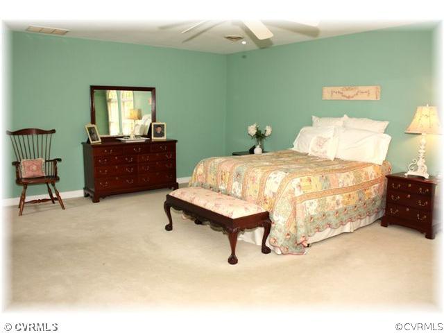 14420 Newgate Road Midlothian, VA 23113 - Photo 6 of 12 a bed sitting in a bedroom next to a window