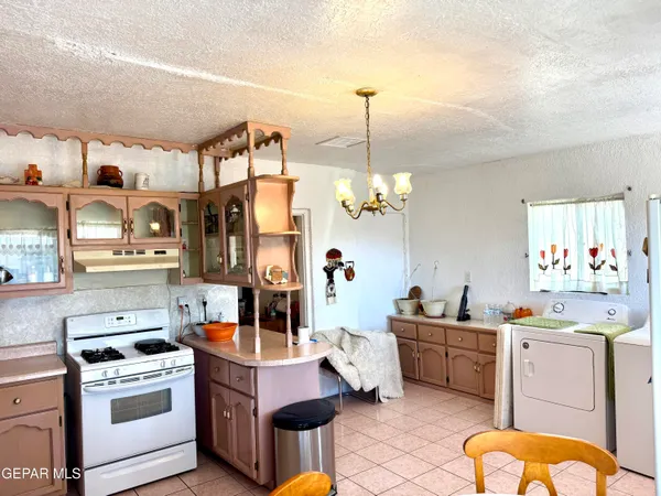 a living room with stainless steel appliances kitchen island granite countertop furniture and a view of living room