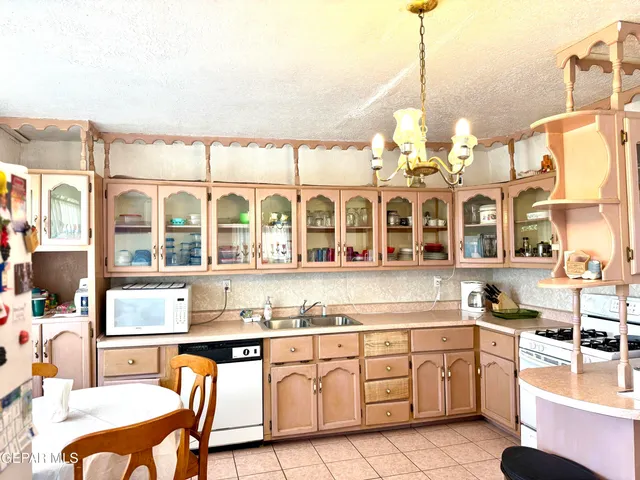 a kitchen that has a lot of cabinets in it