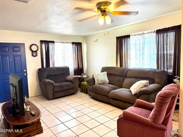 a living room with furniture a fireplace and a window