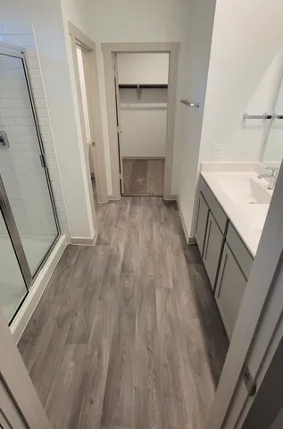 a bathroom with a glass shower door