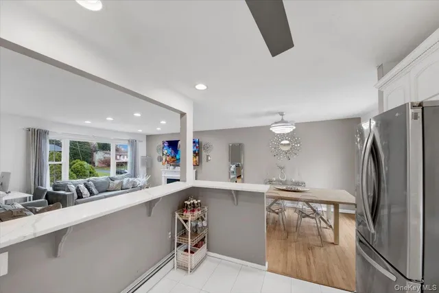 a kitchen with stainless steel appliances a refrigerator sink and microwave