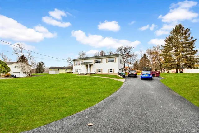 a view of a car park in front of a house