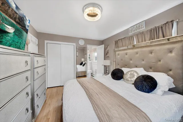 a bedroom with furniture and a flat screen tv