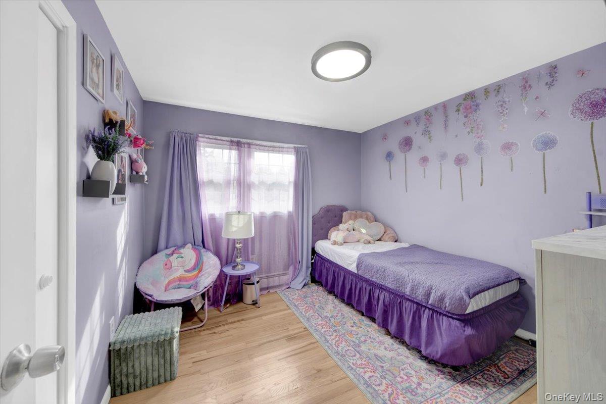 10 Scott Drive Middletown, NY 10941 - Photo 27 of 33 a bedroom with a bed and wooden floor