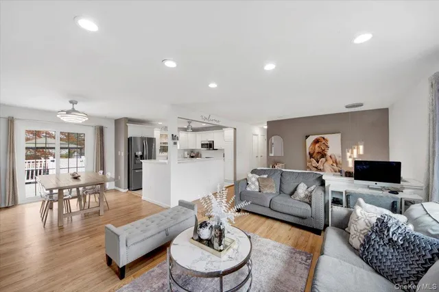 a living room with furniture flat screen tv and a fireplace