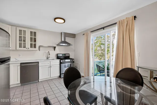 a kitchen with a stove a refrigerator and a sink