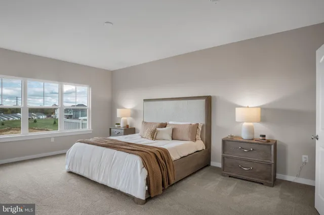 a bedroom with a bed and a large window