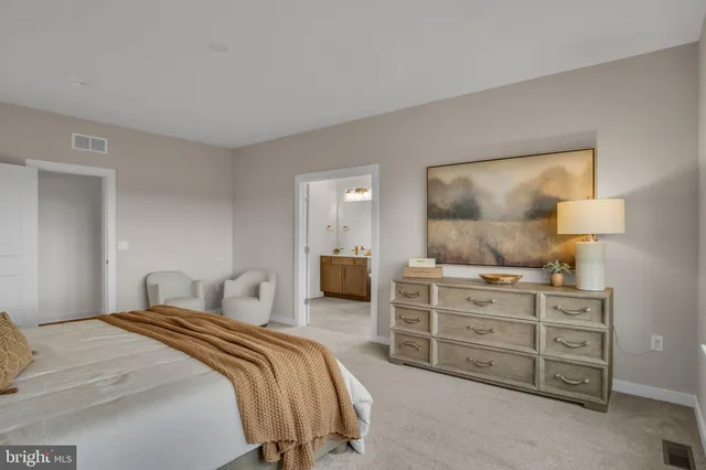 a bedroom with a bed and a dresser