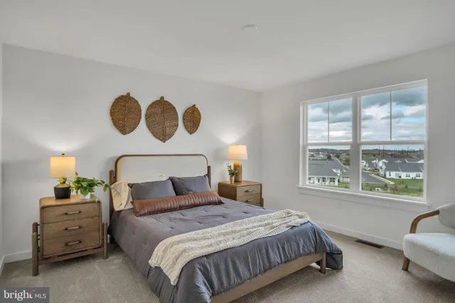 a bedroom with a bed and a large window