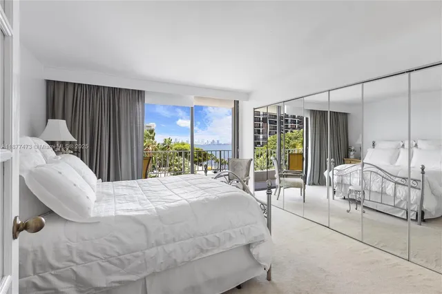 a bedroom with a bed and large window