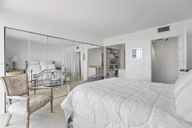 a bedroom with a bed and a mirror