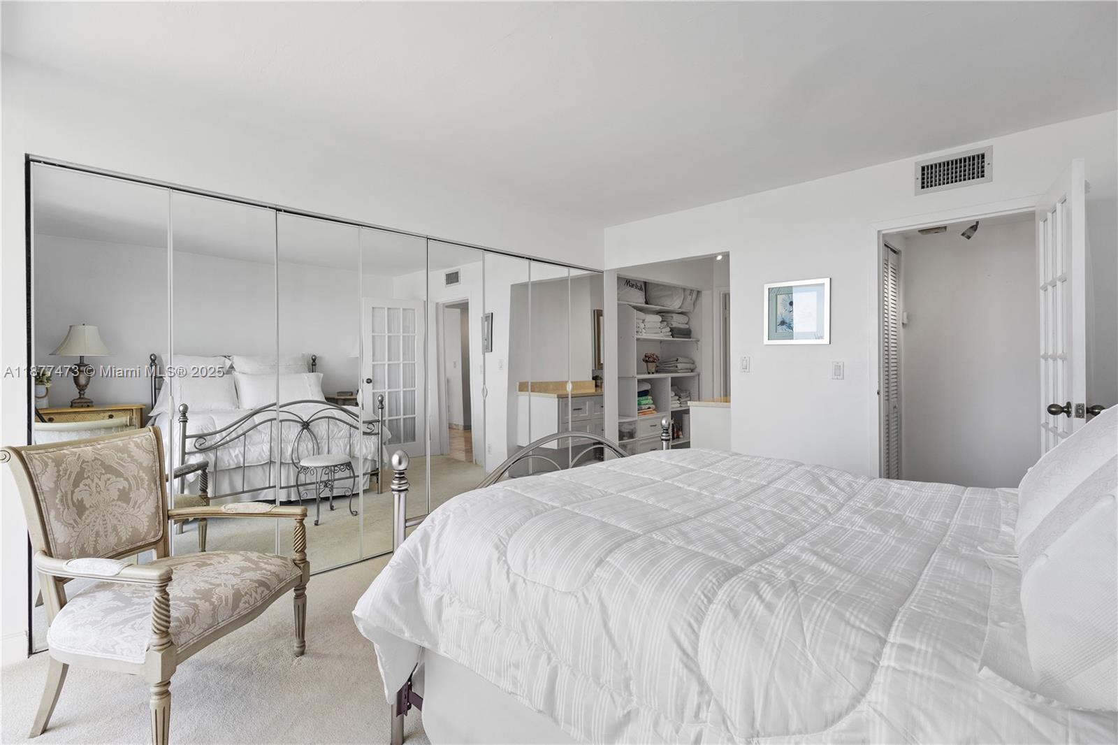 200 Southeast 15th Road, Unit 6F Miami, FL 33129 - Photo 25 of 38 a bedroom with a bed and a mirror