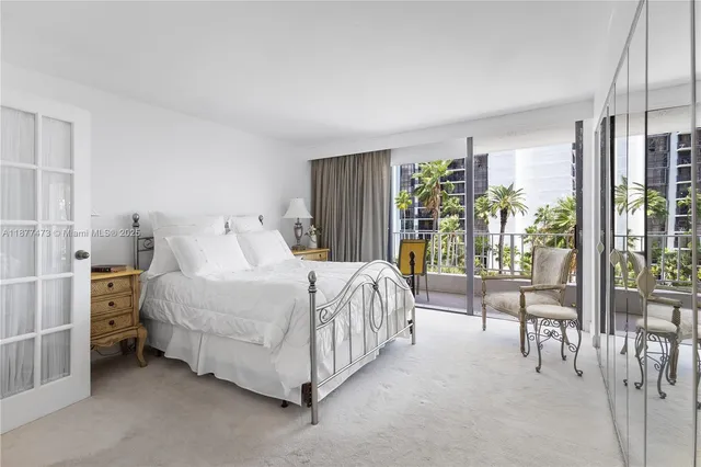 a spacious bedroom with a bed and a large window