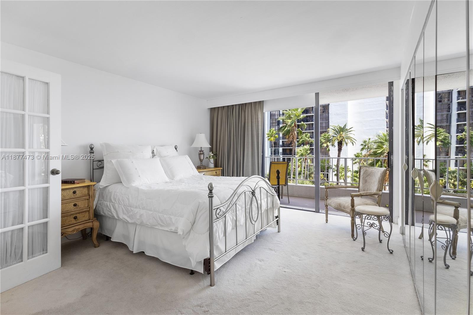 200 Southeast 15th Road, Unit 6F Miami, FL 33129 - Photo 26 of 38 a spacious bedroom with a bed and a large window