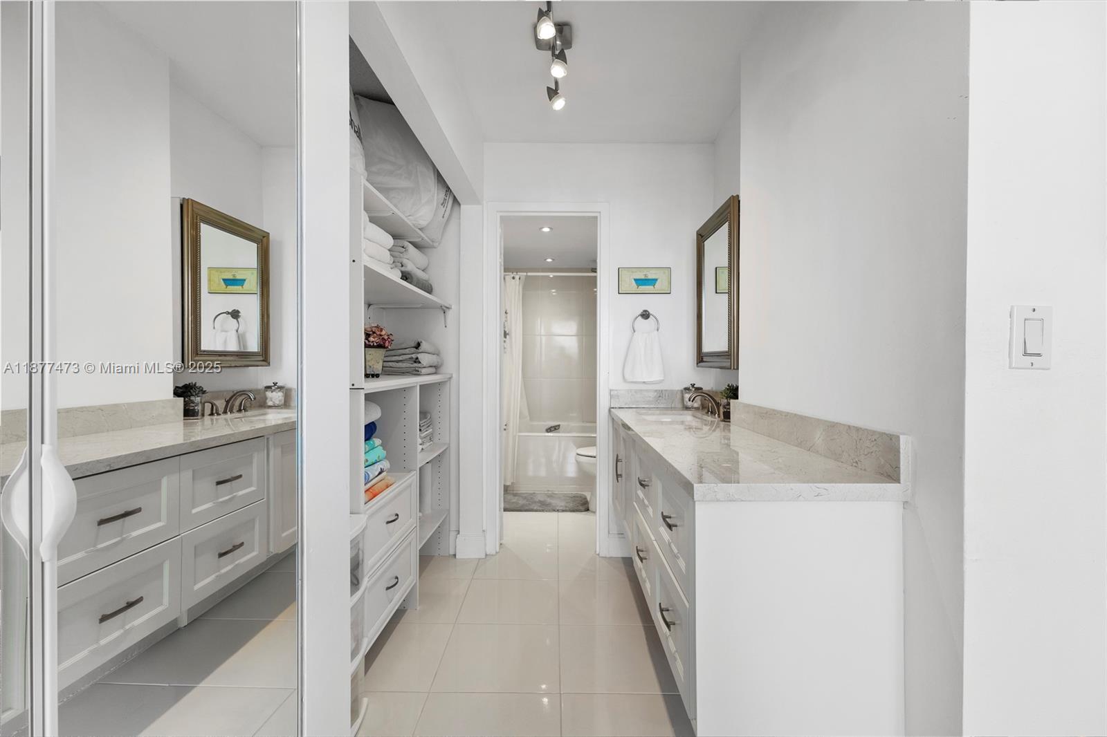 200 Southeast 15th Road, Unit 6F Miami, FL 33129 - Photo 27 of 38 a bathroom with a sink a toilet and a mirror