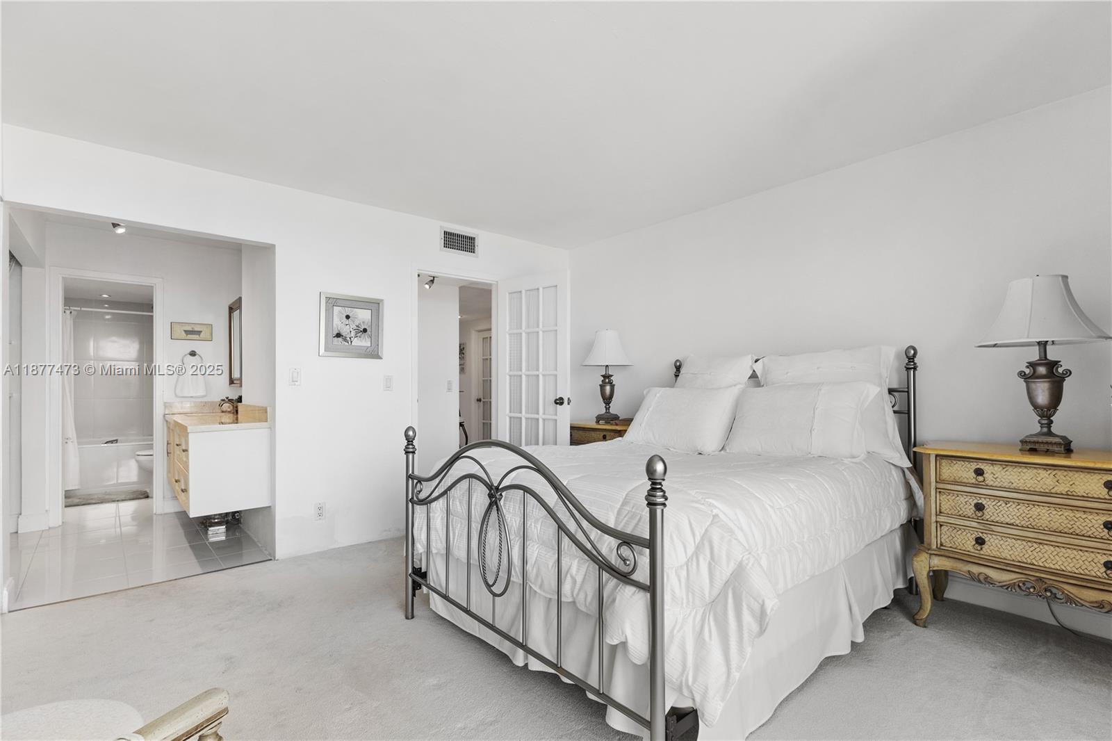 200 Southeast 15th Road, Unit 6F Miami, FL 33129 - Photo 31 of 38 a bedroom with bed and a chandelier