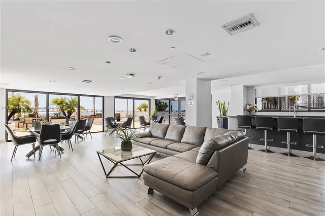 a dining room with furniture and wooden floor