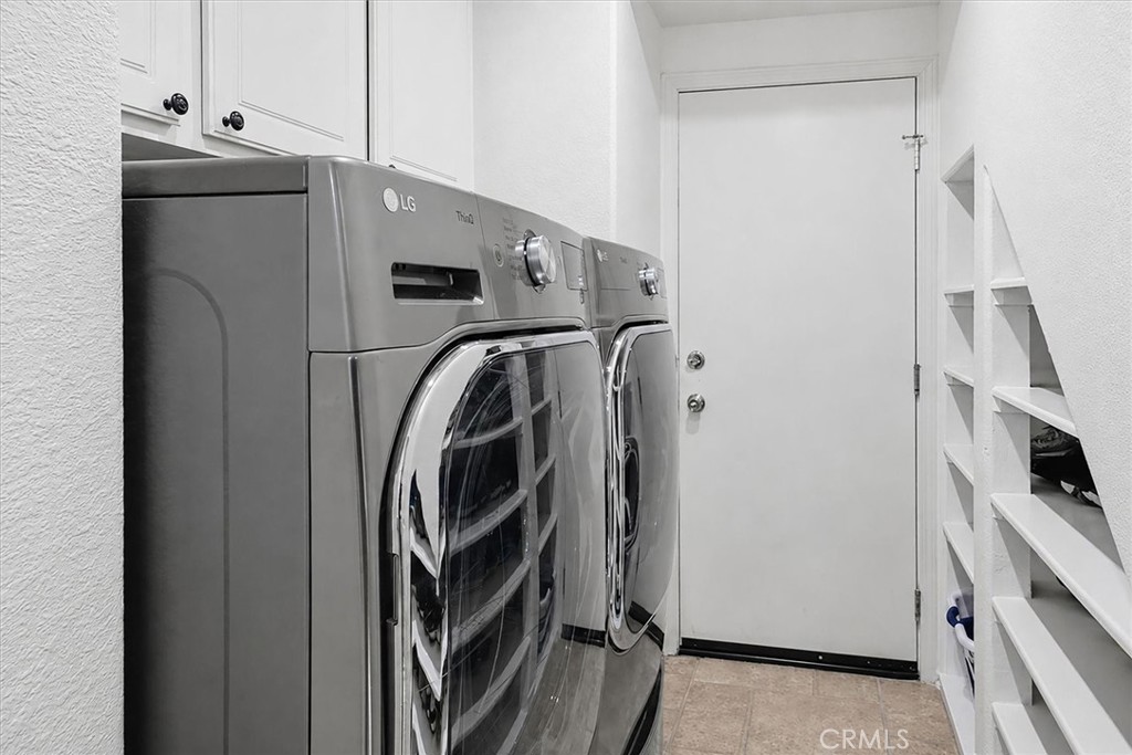25443 Hopkins Place Stevenson Ranch, CA 91381 - Photo 57 of 68 Laundry room with storage leading to garage