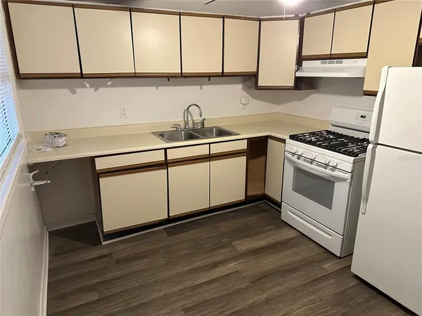 a kitchen with a sink cabinets and stainless steel appliances