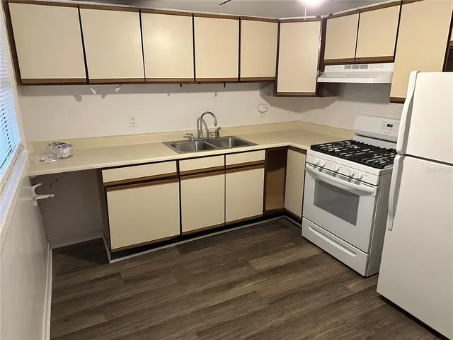 a kitchen with a sink cabinets and stainless steel appliances