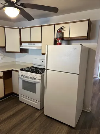 a kitchen with a refrigerator and a stove