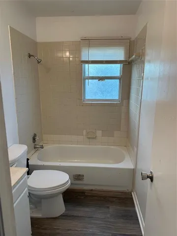 a bathroom with a toilet and a bathtub